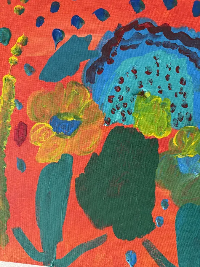 A child's bright painting in orange, teal and yellow
